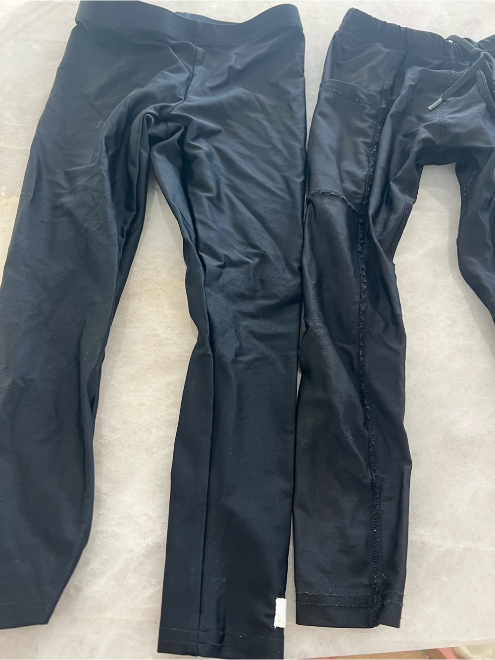 One pair Dovio and one pair kozie black spf swim pants, size 3t
